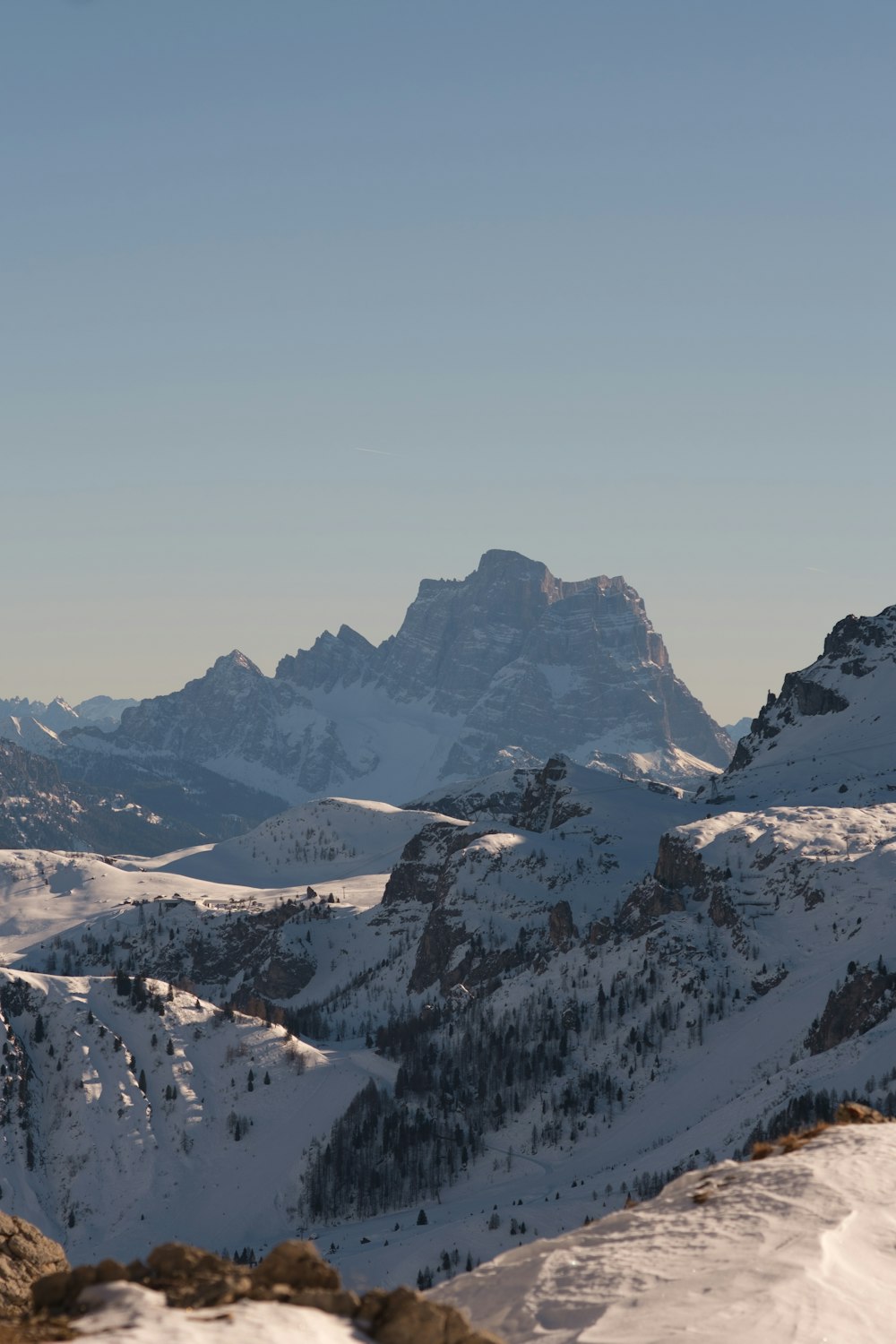 a person standing on top of a snow covered mountain