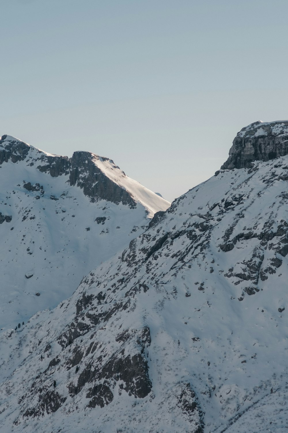 a snow covered mountain with a sky background