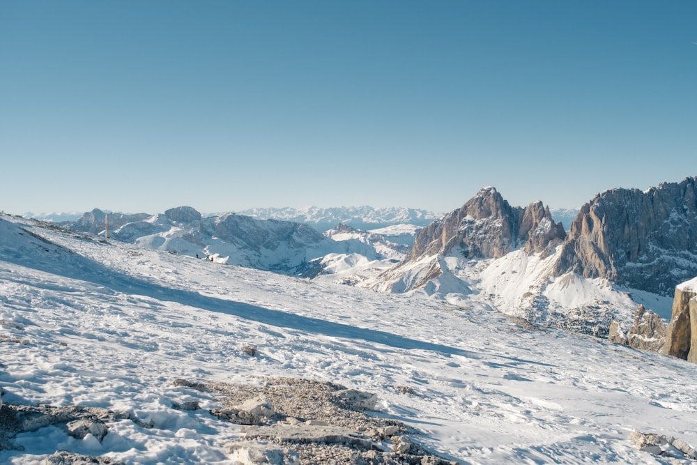 a man standing on top of a snow covered mountain