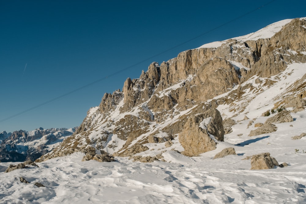 a man riding skis down a snow covered slope