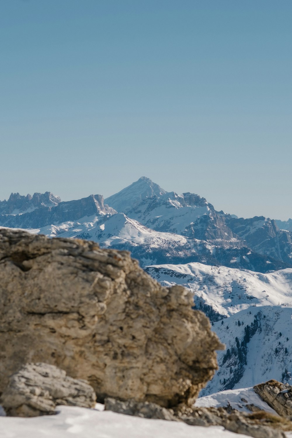 a person standing on top of a snow covered mountain