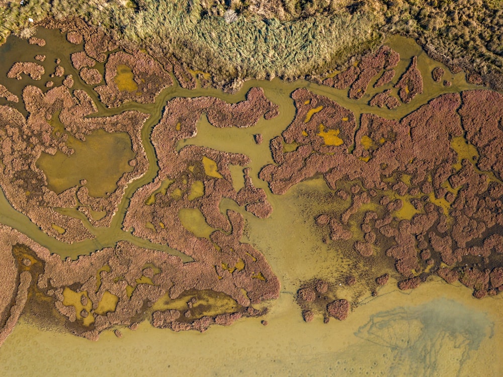 an aerial view of a muddy area with water