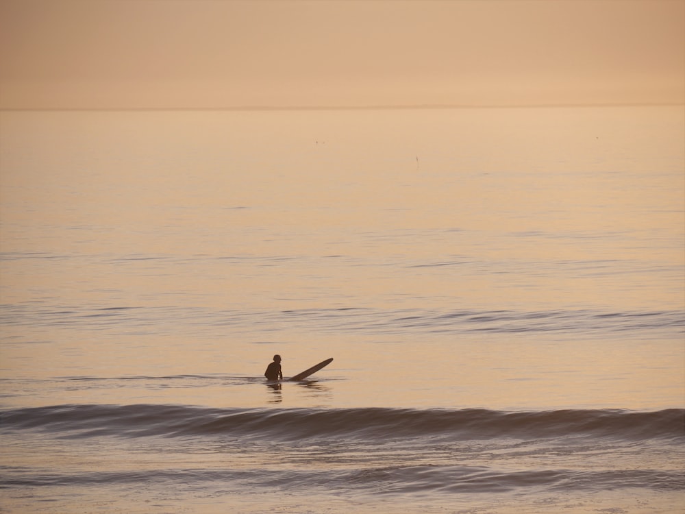 a person riding a surfboard on a wave in the ocean