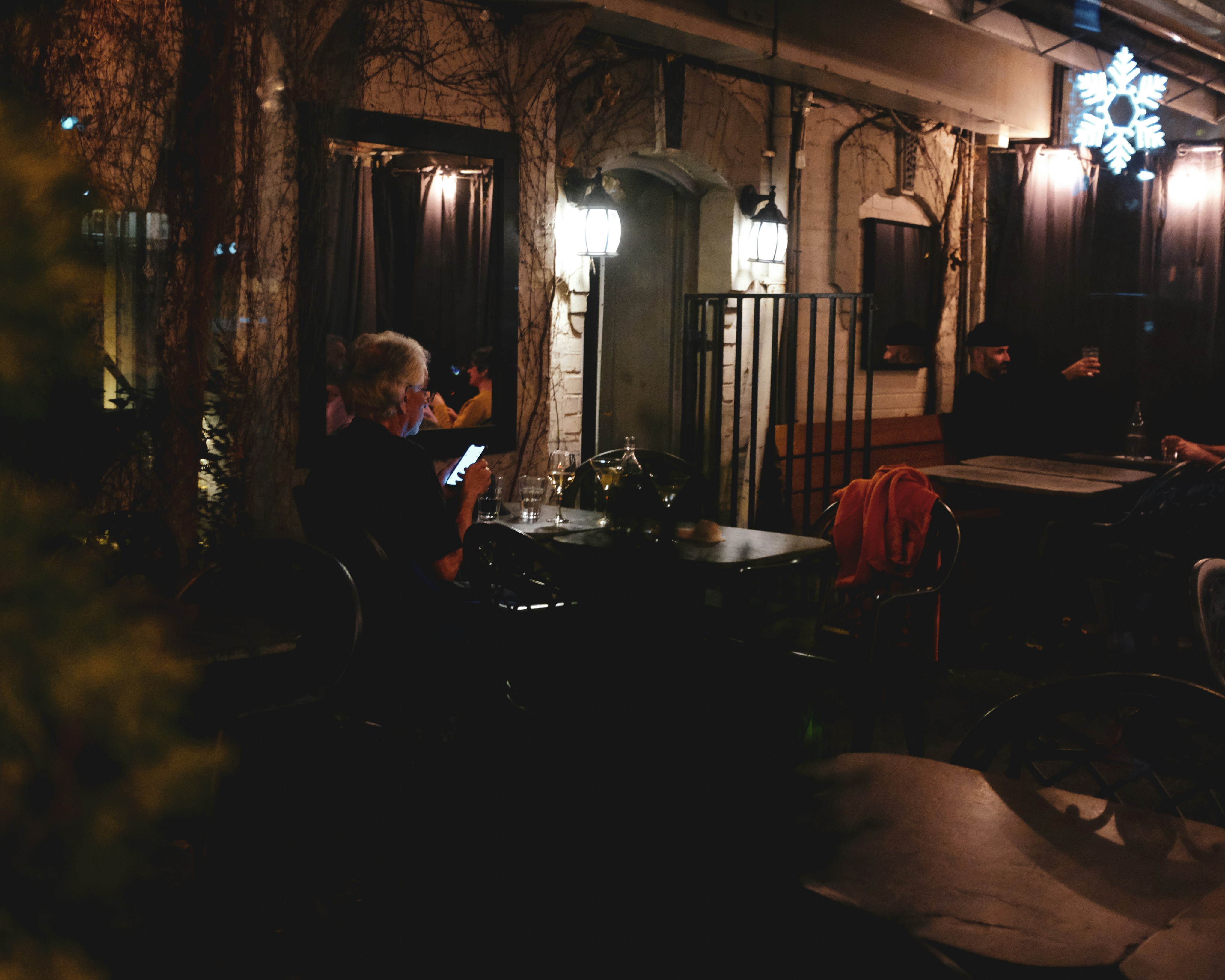 a group of people sitting around a table in a dark room