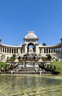 a large building with a fountain in front of it