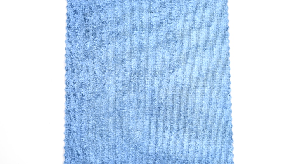 a blue rug with a white background