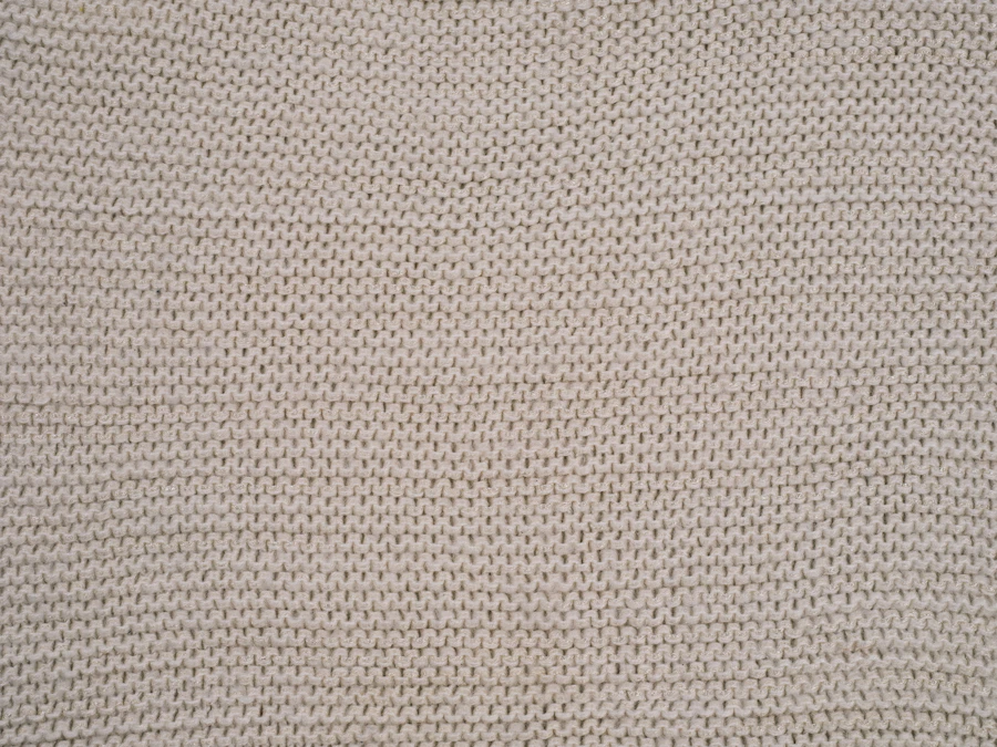 Macro detail of a fine bamboo jersey in oat, showing the loop structure
