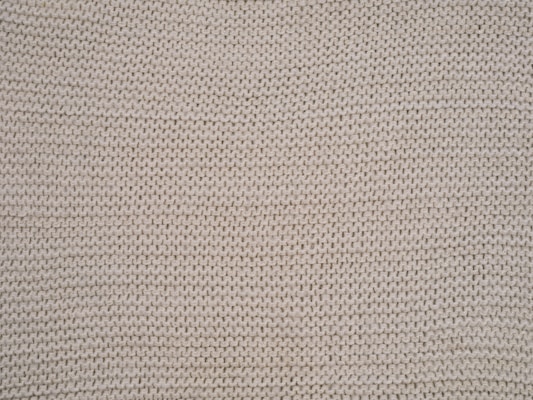 Close-up of white knitted wool material