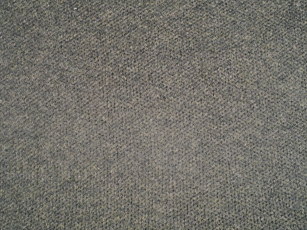 a close up of a gray carpet with a pattern