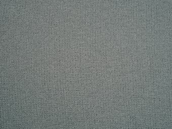A textured surface featuring a tightly woven fabric with a uniform pattern in shades of gray-green.