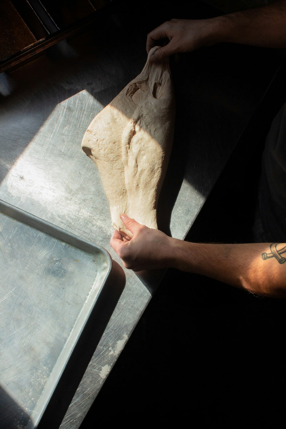 a person holding a piece of bread in their hand