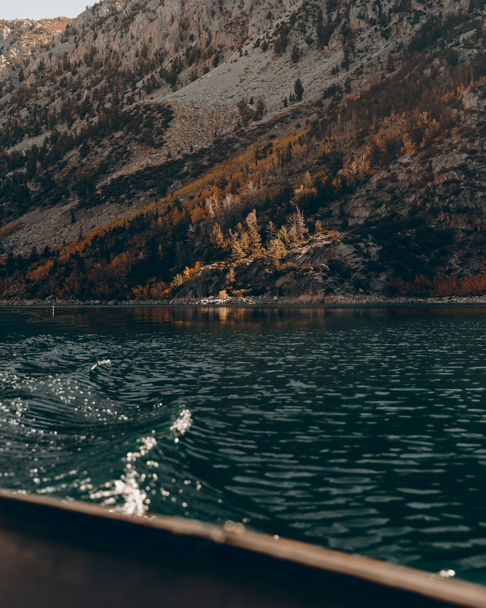 a body of water with a mountain in the background