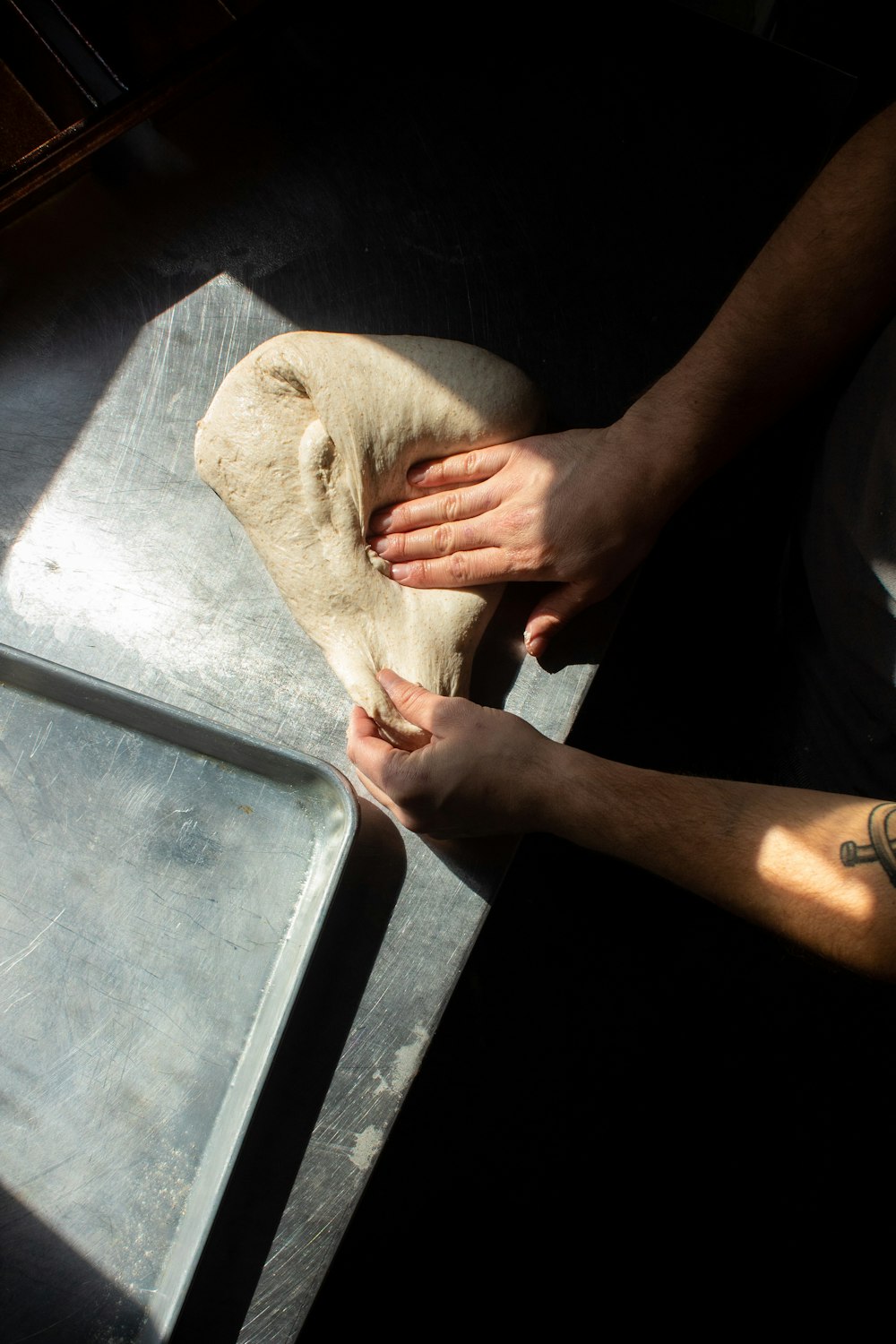 a person is kneading dough on a table