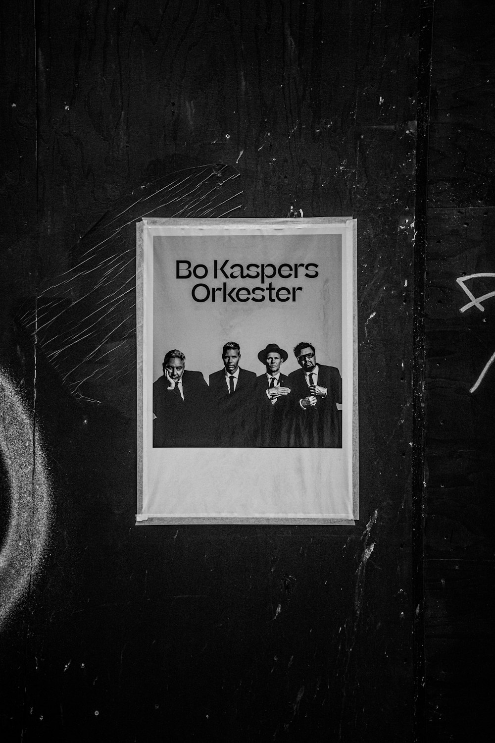 a black and white photo of a poster on a wall