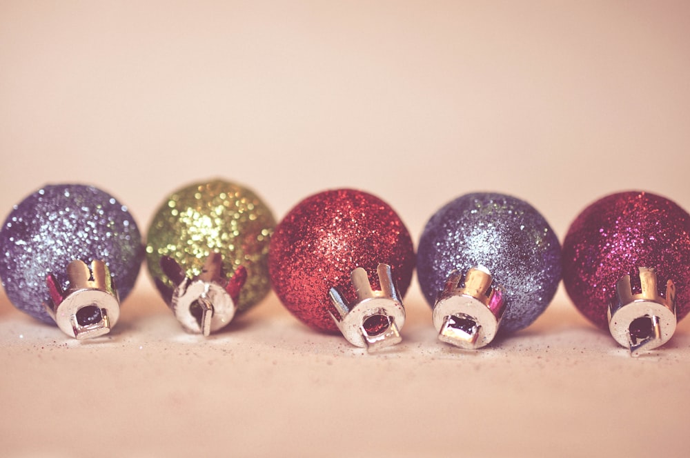 a row of colorful christmas ornaments sitting on top of a table
