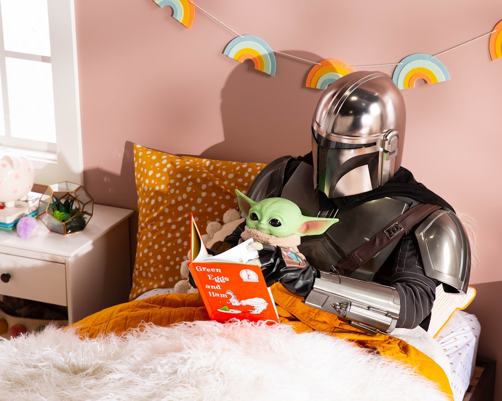 a child in a star wars costume reading a book
