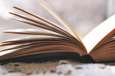 an open book sitting on top of a carpet