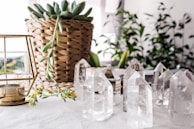 An arrangement of colorful crystal points on a wooden altar with candles
