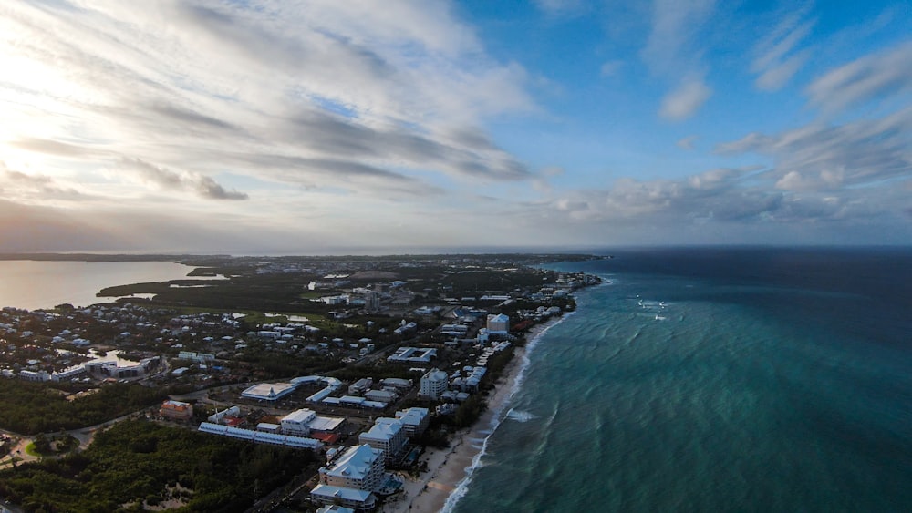 an aerial view of a city next to the ocean