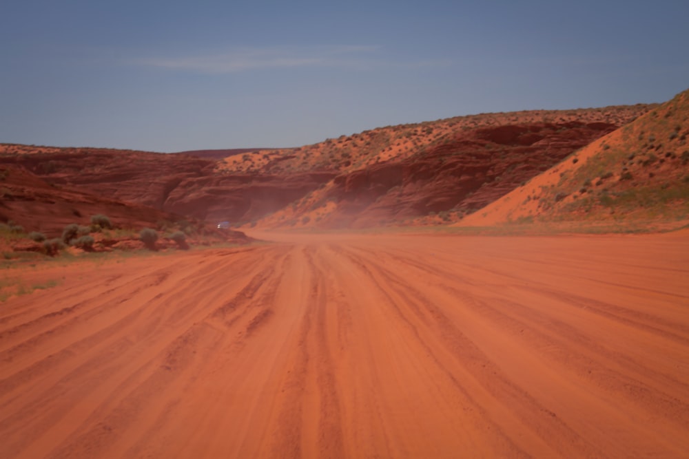 a dirt road in the middle of a desert