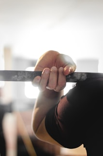 Close-up of hands gripping gymnastic rings during practice.