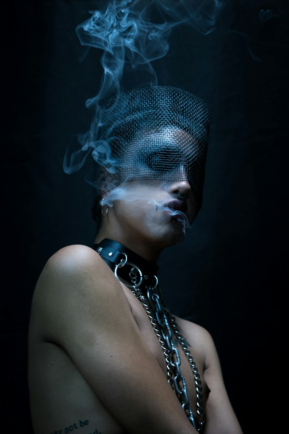 a woman with a chain around her neck and smoke coming out of her mouth
