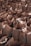 Numerous brown paper bags are arranged closely together in a densely packed manner. Some bags contain items that slightly protrude or are visible from the top.