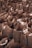 Numerous brown paper bags are arranged closely together in a densely packed manner. Some bags contain items that slightly protrude or are visible from the top.