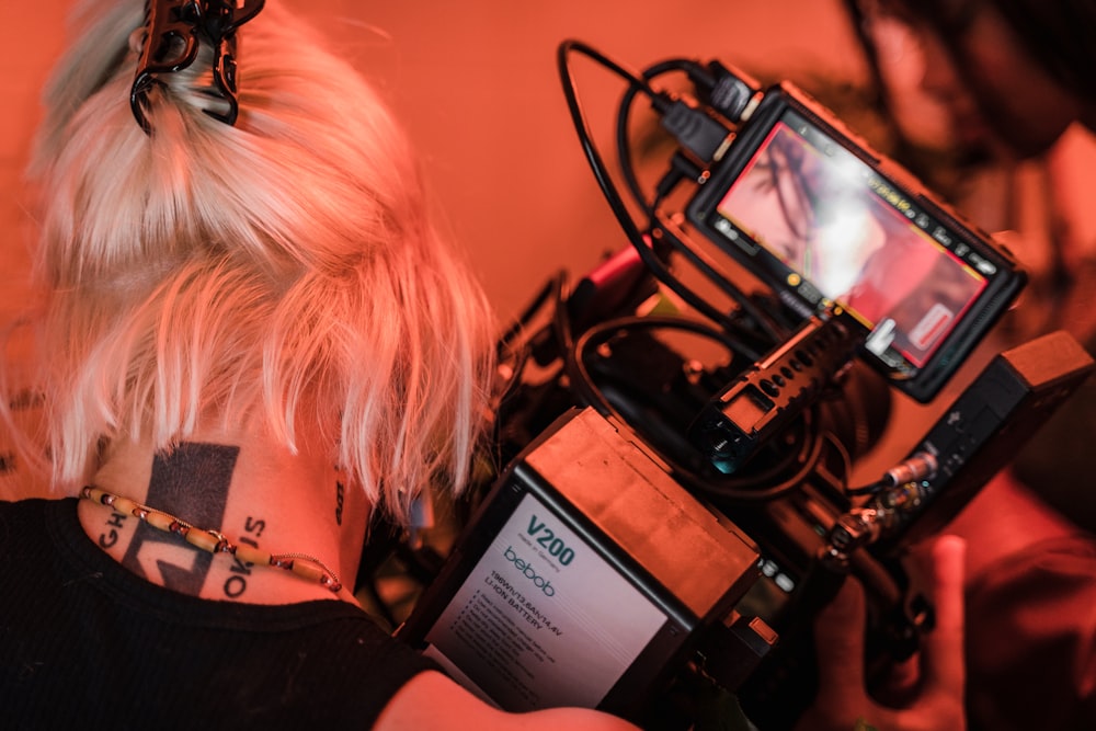 a woman with a tattoo on her neck looking at a camera