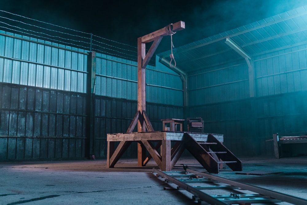 a wooden structure in a warehouse with smoke coming out of it