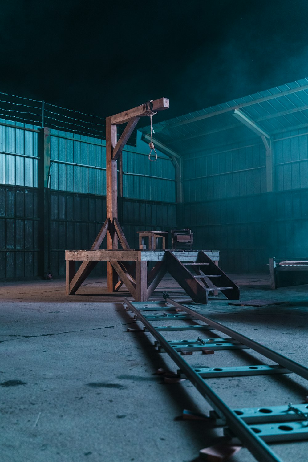 a train track in a building with a green light