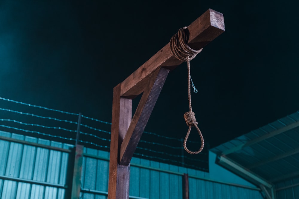 a rope tied to a wooden post in front of a building