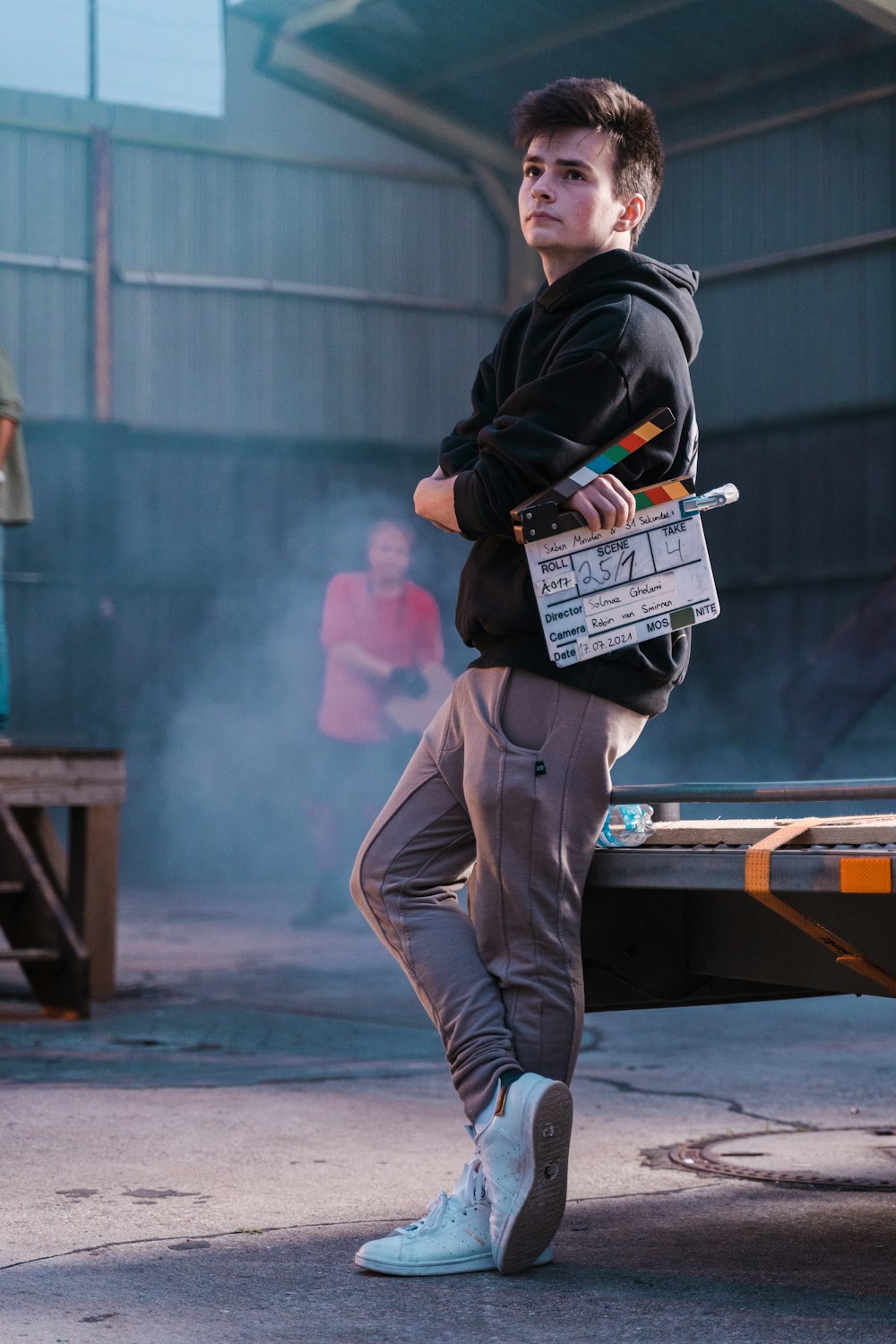 a young man standing next to a truck