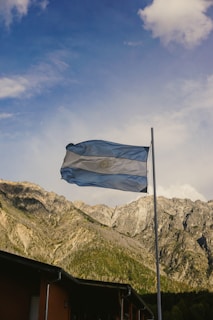 a flag flying in front of a mountain range