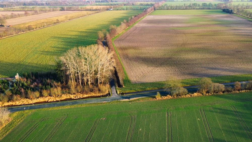 an aerial view of a farm and road