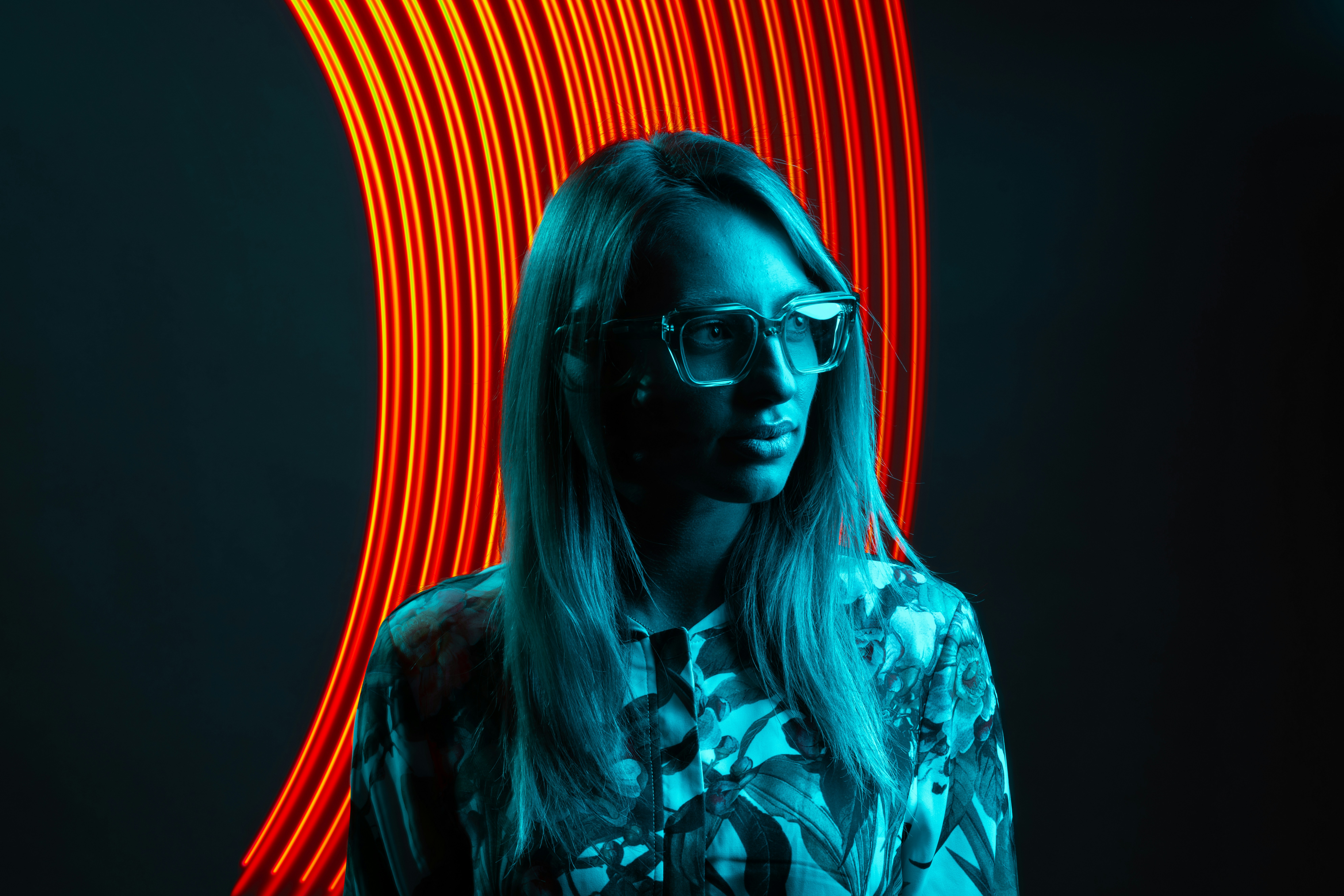 Artist Zara Nix with abstract purple and blue light patterns