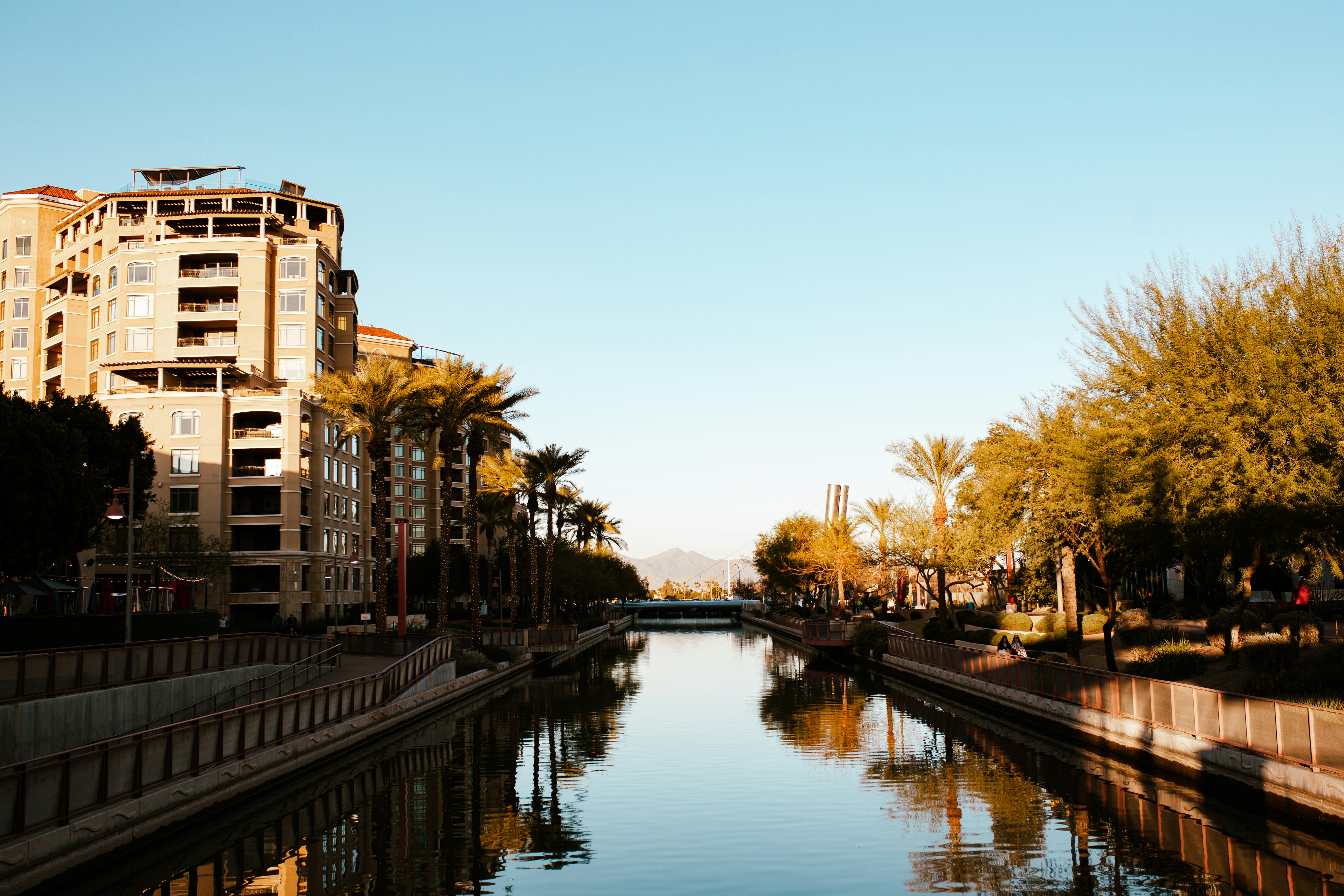 a river running through a city next to tall buildings