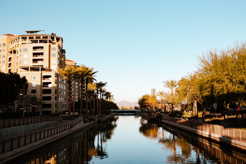 a river running through a city next to tall buildings