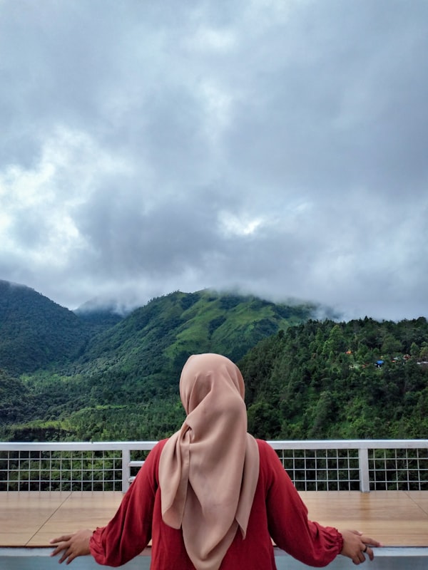 Srikandi traveler overlooking a misty mountain valley