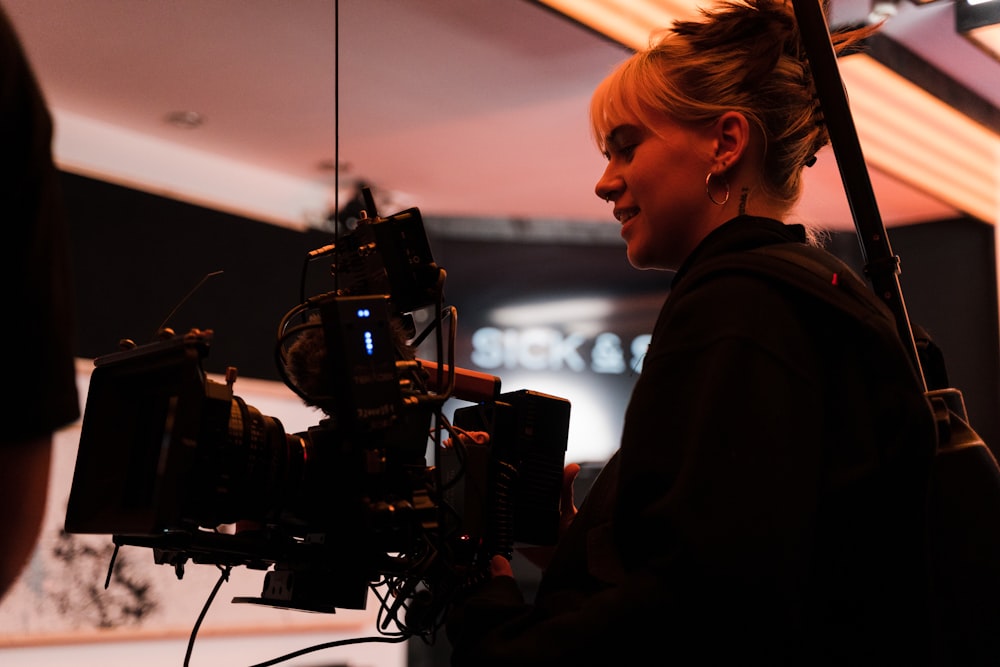 a woman standing in front of a camera