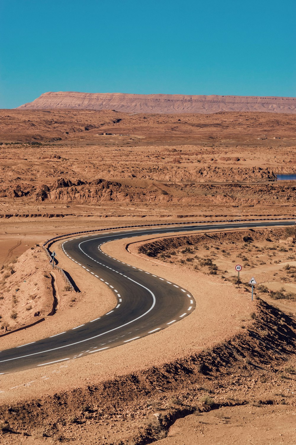 a winding road in the middle of a desert