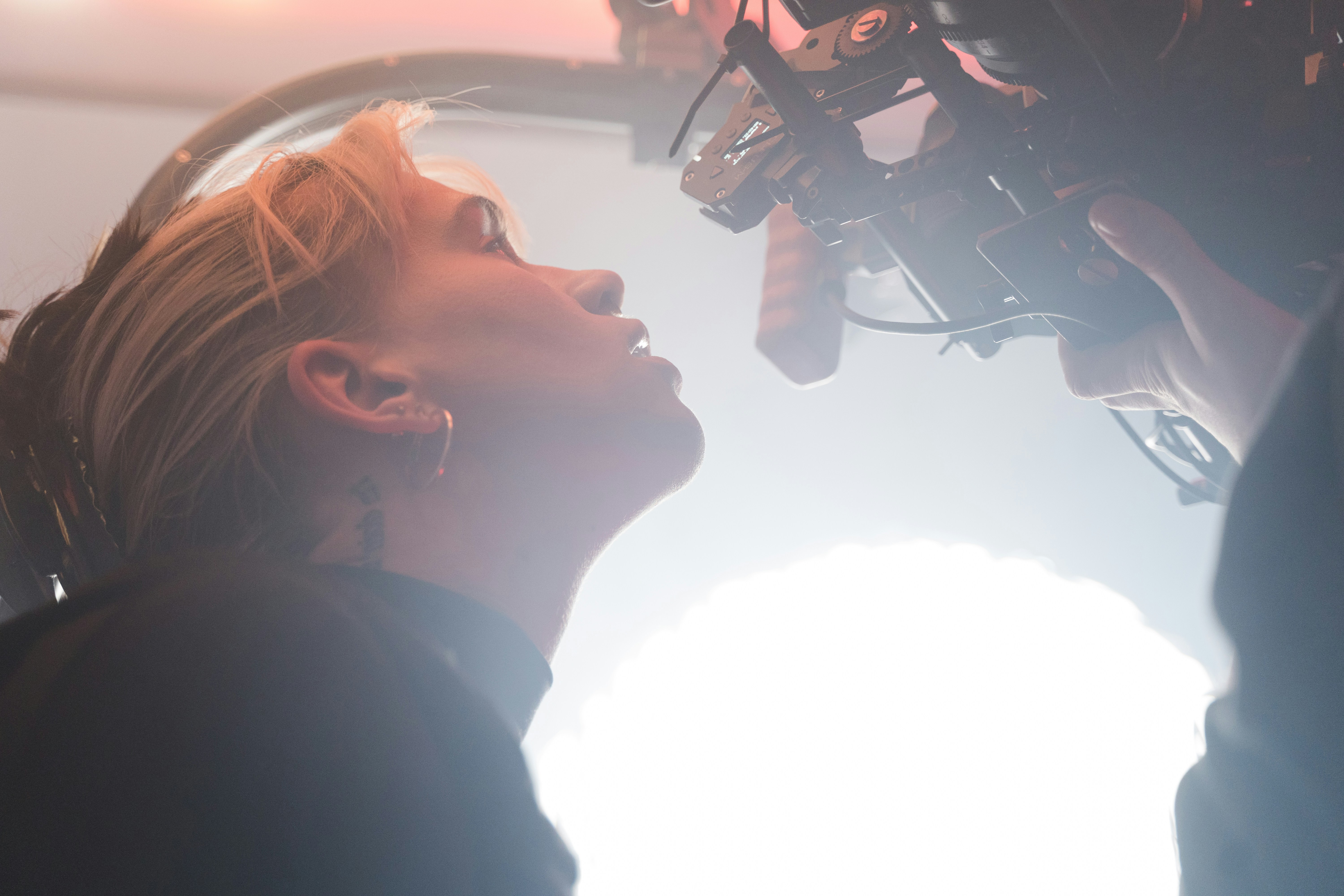 a woman standing in front of a camera