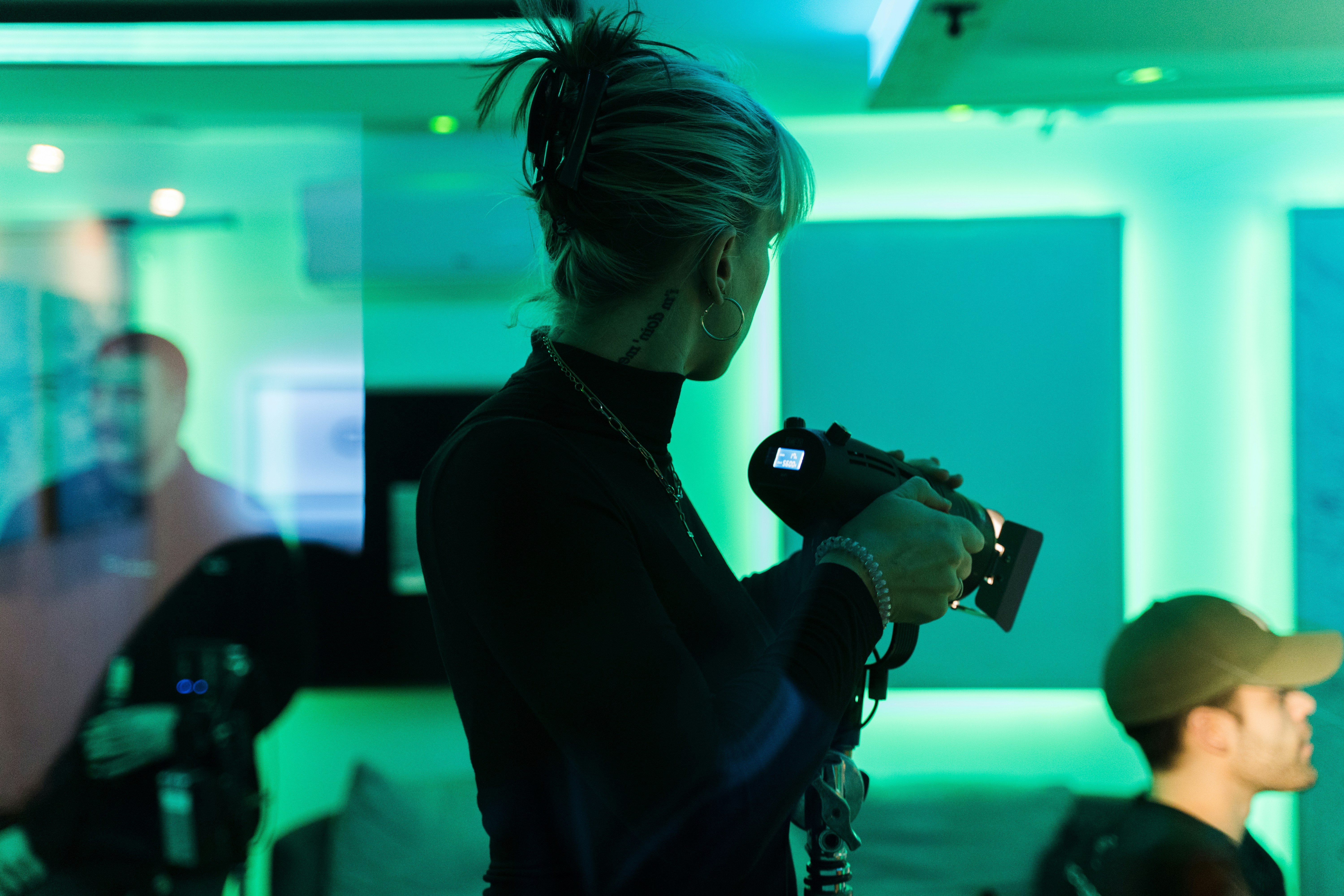 a woman holding a camera while standing next to a man