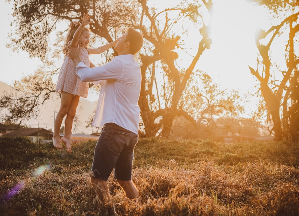 a man and a woman standing in a field