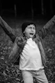 a young boy with his hands up in the air