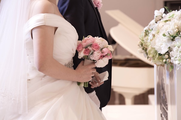 a bride and groom standing in front of a piano