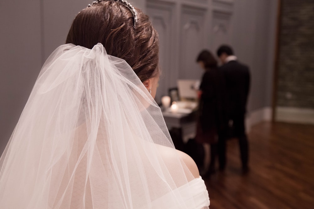 the back of a bride's veil as she walks down the aisle