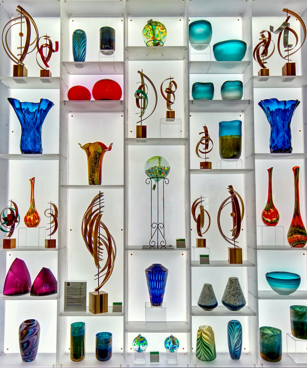 a display case filled with lots of different colored vases