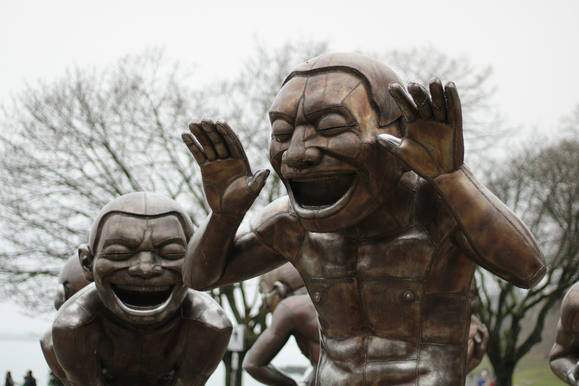 a statue of a man holding his hands up to his face