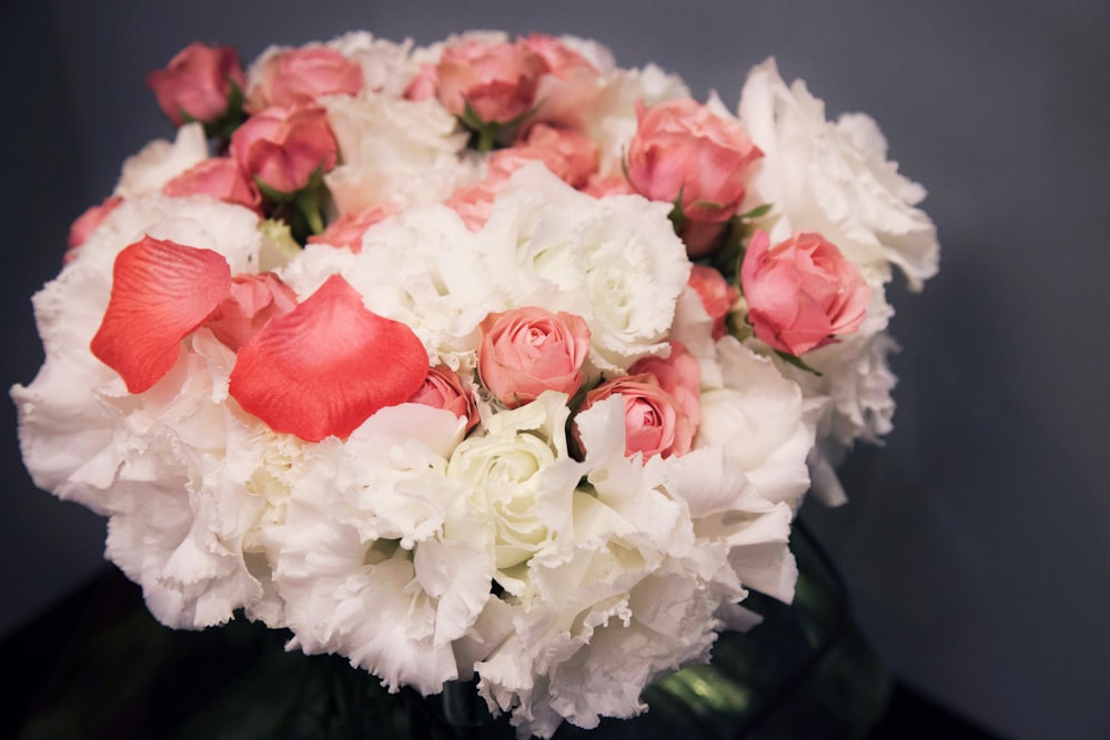 a vase filled with white and pink flowers